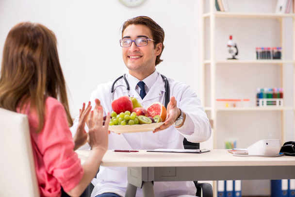 Pregnant woman visiting doctor discussing healthy diet - Photo, Image