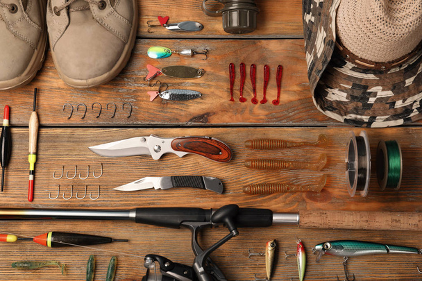 Flat lay composition with fishing equipment on wooden background - Foto, afbeelding