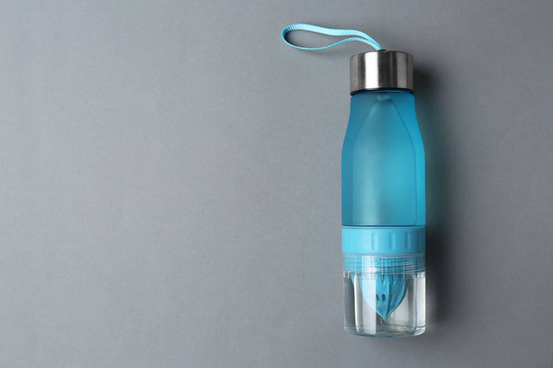 Sport bottle with space for text on color background, top view - Foto, afbeelding