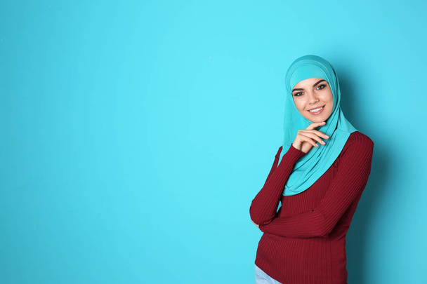Portrait of young Muslim woman in hijab against color background. Space for text - Fotografie, Obrázek