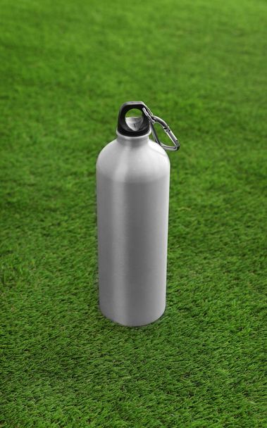 Bottle of water on artificial grass. Fitness equipment - Φωτογραφία, εικόνα
