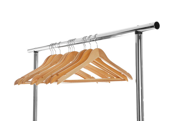 Wardrobe rack with wooden hangers isolated on white - Foto, afbeelding