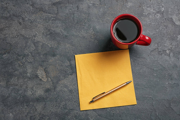Clean napkin, cup of coffee and pen on grey background, top view with space for text - Φωτογραφία, εικόνα