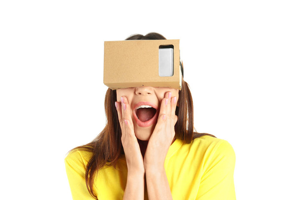 Young woman using cardboard virtual reality headset, isolated on white - Fotó, kép