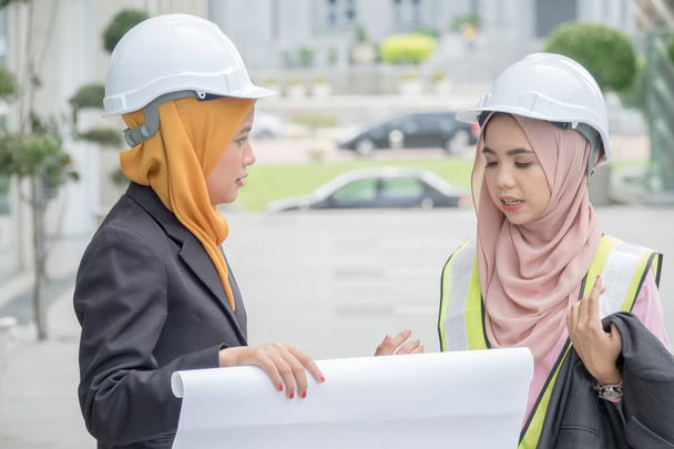 Professional woman engineers are discussing on construction at outdoor. - Photo, Image