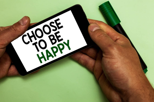 Uwaga piśmie Wyświetlono wybrać aby być szczęśliwym. Biznesowe zdjęcie formacie prezentującym Decide jest w dobry humor uśmieszek wesoły zadowolony cieszyć się ludzką ręką trzymać iphone z tekstów dotknął zielony znacznik. - Zdjęcie, obraz