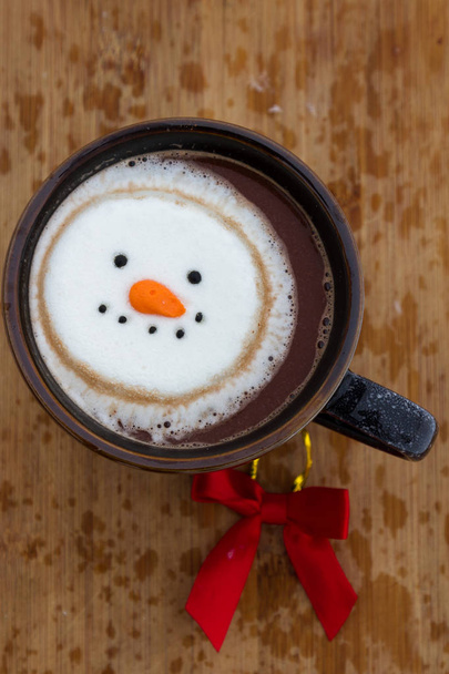 warme cacao drank gemengd met Ierse whiskey gegarneerd met een lachende sneeuw-persoon marshmallow - Foto, afbeelding