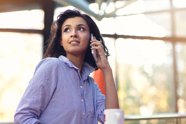 Portrait Of Young Girl Talking On phone while drinking coffee - Φωτογραφία, εικόνα