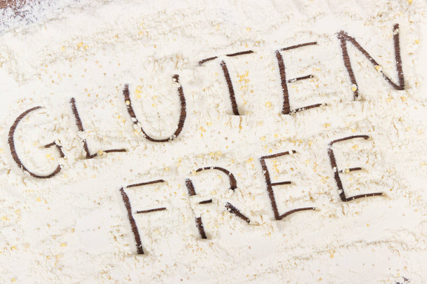Inscription gluten free with millet groats and heap of flour, concept of healthy +food - Foto, Imagen