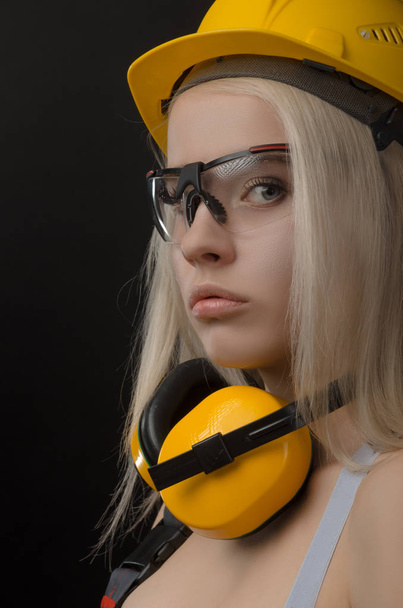girl in a construction firm works with a tape measure - Φωτογραφία, εικόνα
