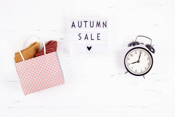 Creative Top view flat lay promotion composition Autumn sale text on lightbox white background copy space Template Autumn sale mockup fall seasonal offer promotion advertising with alarm clock - Фото, изображение