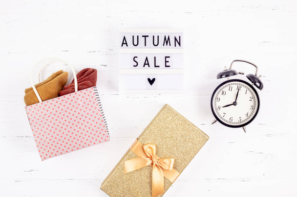 Creative Top view flat lay promotion composition Autumn sale text on lightbox white background copy space Template Autumn sale mockup fall seasonal offer promotion advertising with alarm clock - Valokuva, kuva