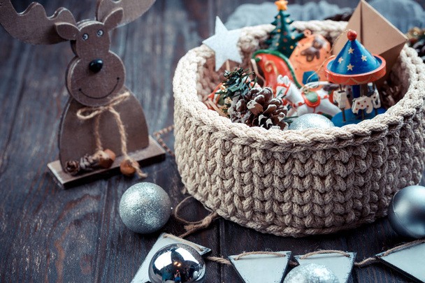 Christmas toys for Christmas tree in wicker red basket - Foto, Imagen