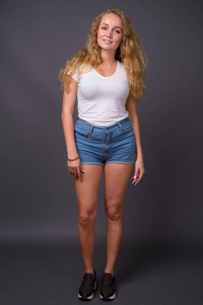 Full length portrait of young beautiful woman with long wavy blond hair - Photo, image