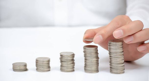 Hand of a business man pile up coins. Financial Concept. - Φωτογραφία, εικόνα