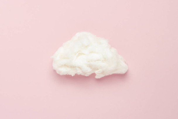 Cloud of cotton wool on a pink background. Concept of rain, rain. Flat lay, top view - Photo, Image