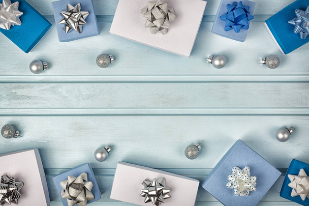 Gift boxes and small Christmas balls lying on light background - Photo, image