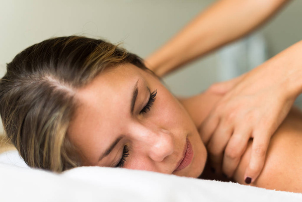 Young woman having a massage in a spa - Φωτογραφία, εικόνα