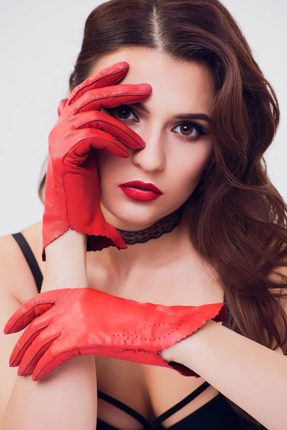 Retro red silk gloves, dark dress, woman with curly hair, brunette girl on white background - Foto, afbeelding