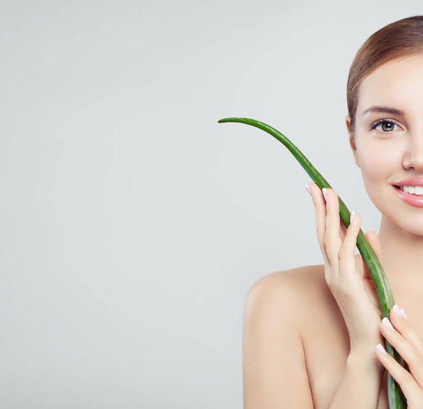 Beautiful smiling woman with healthy skin and aloe vera leaf, skincare concept - Fotoğraf, Görsel