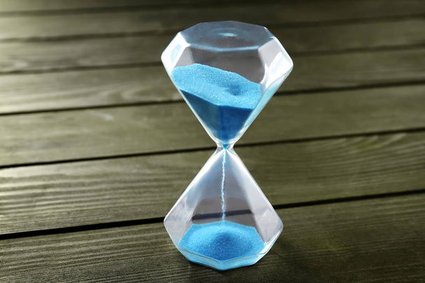 Hourglass on wooden background. Time management concept - Photo, Image