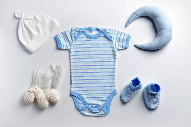Lindo bebé ropa y juguetes sobre fondo blanco
 - Foto, imagen