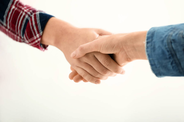 People shaking hands on white background - Foto, afbeelding