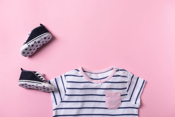 Baby clothes and shoes on color background, flat lay - Photo, Image