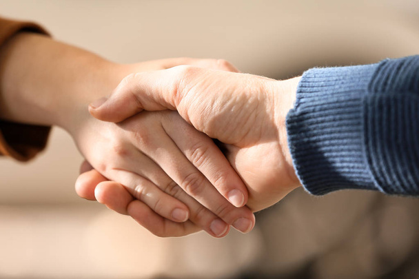 Man and woman shaking hands outdoors, closeup - Photo, Image