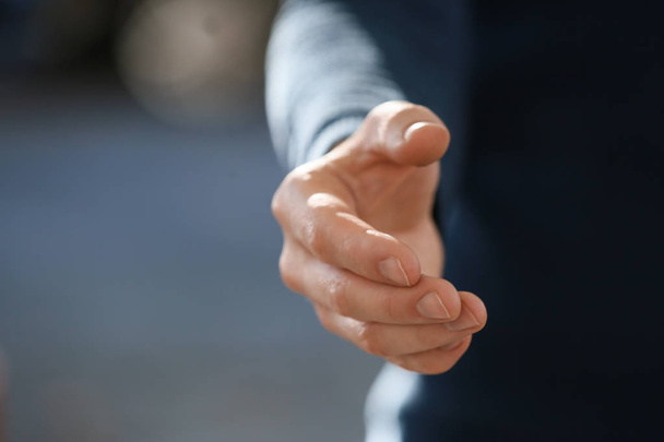 Man stretching hand for handshake outdoors, closeup - Фото, зображення