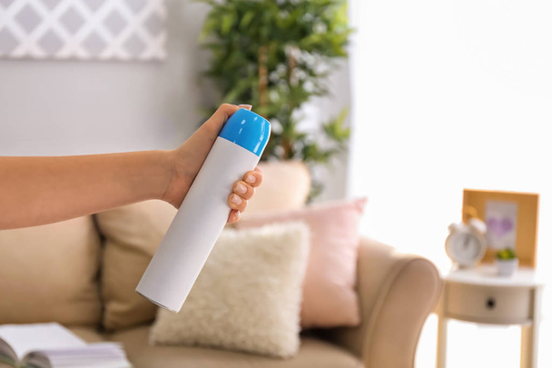 Woman holding air freshener at home - Photo, Image