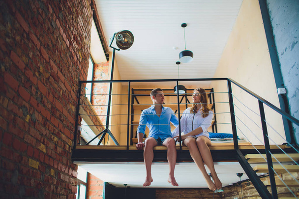 couple at home sitting on the second floor - Foto, imagen