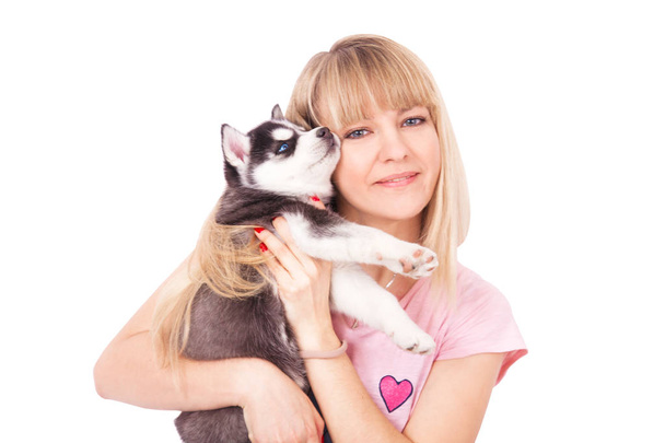 Happy women with her puppy Husky in the studio. Isolated on white background. - Fotoğraf, Görsel