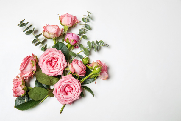 Beautiful pink roses with eucalyptus branches on white background - Photo, Image