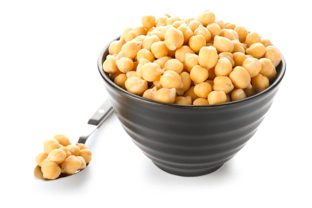 Bowl and spoon with chickpeas on white background - Photo, Image