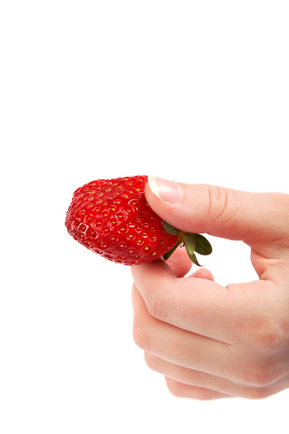 Juicy strawberry in a female hand isolated on white background. - 写真・画像
