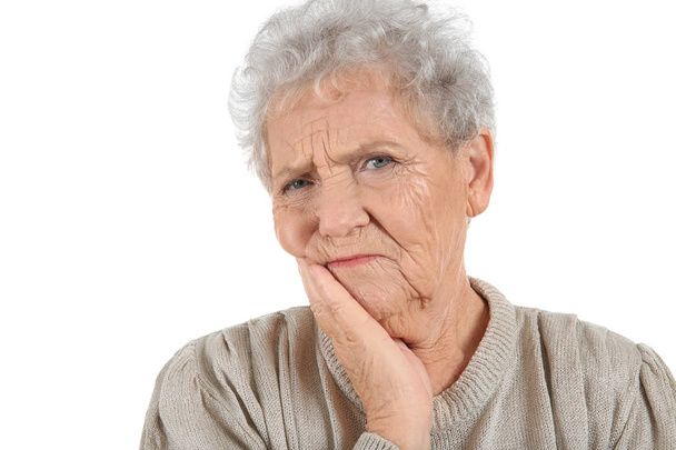 Senior woman suffering from toothache on white background - Foto, Bild