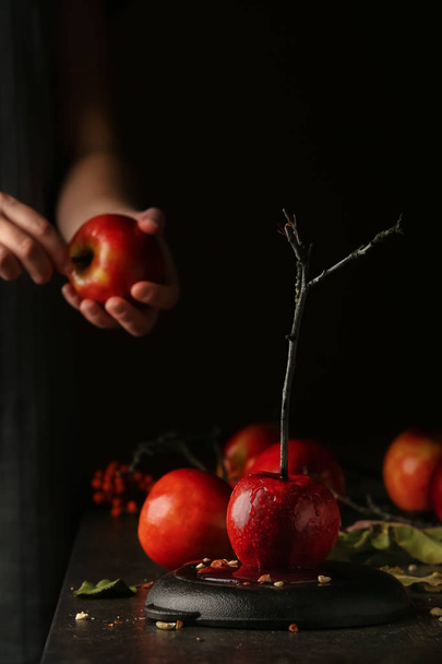 Tasty candy apple on dark table - Photo, Image