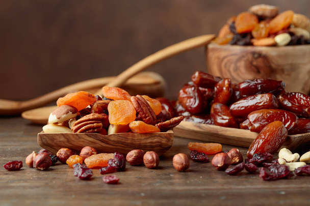 Various dried fruits and nuts on a old wooden table. - Photo, Image