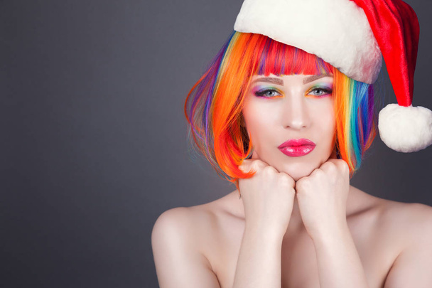 Beautiful model with red santa hat on head - Photo, image