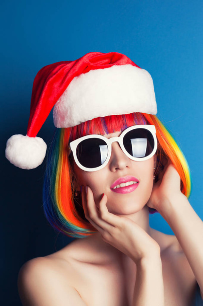 Beautiful model with red santa hat on head - Фото, зображення