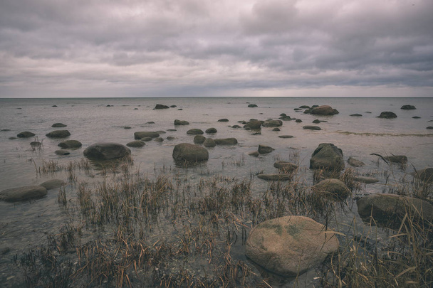 kayalık sahil şeridine Letonya akış su deniz ve geç sonbaharda büyük kayalar. mat renkler - retro vintage bak - Fotoğraf, Görsel