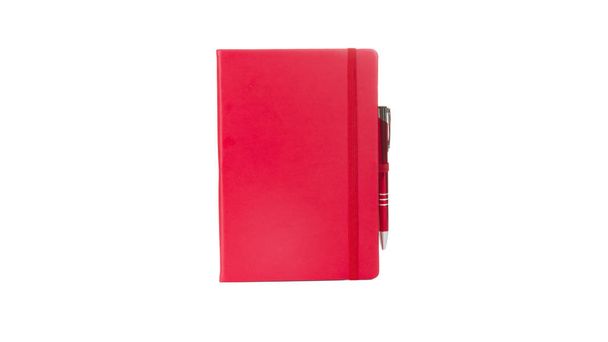 Red Leather PU Agenda Diary Notebook with pen holder isolated on white background. In stationery, diary or appointment book is small book containing a main diary section with space for each day. - Photo, Image
