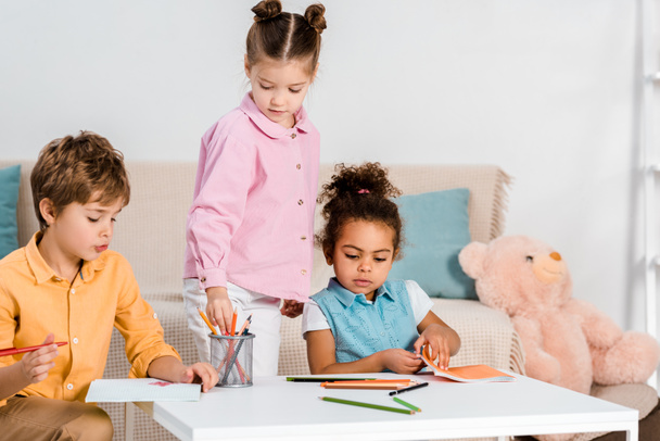 adorable multiethnic children drawing and studying together  - Φωτογραφία, εικόνα