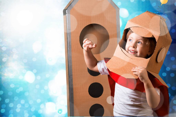 Child with cardboard on head, kid astronaut  - Foto, afbeelding