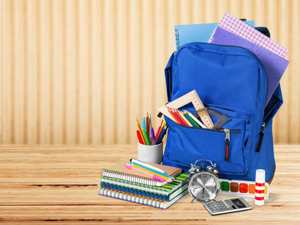 blue backpack and school supplies, back to school  - Фото, изображение