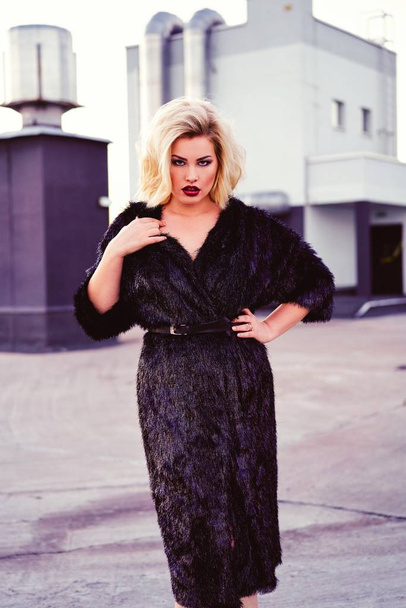 gorgeous young blond woman in fur coat  - Fotó, kép
