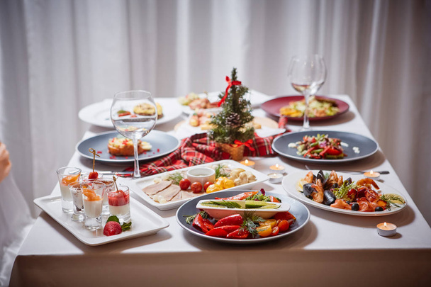 Beautifully served table with food. Festive atmosphere and decor. Celebration together. - 写真・画像