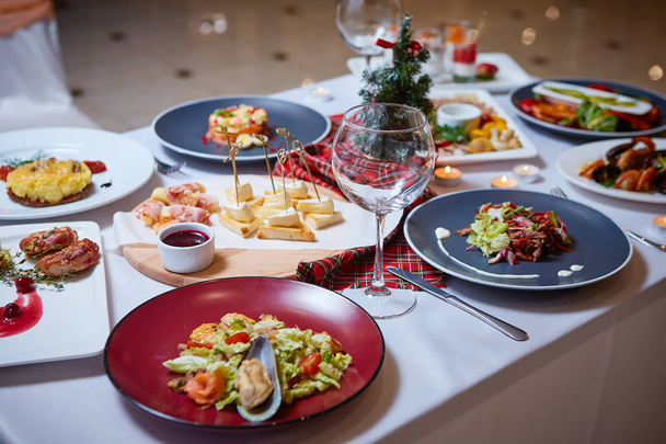 Romantic dinner setup or Holiday table setting. Many varied delicacies. Festive mood. - Foto, Bild