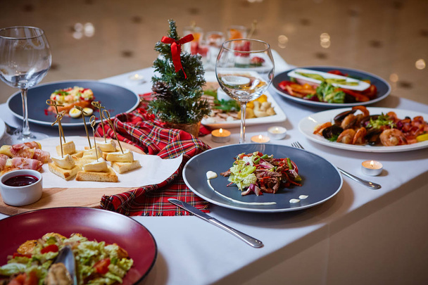 Beautifully served table with food. Festive atmosphere and decor. Celebration together - 写真・画像